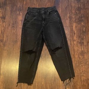Black relaxed mom jeans with rips in knees